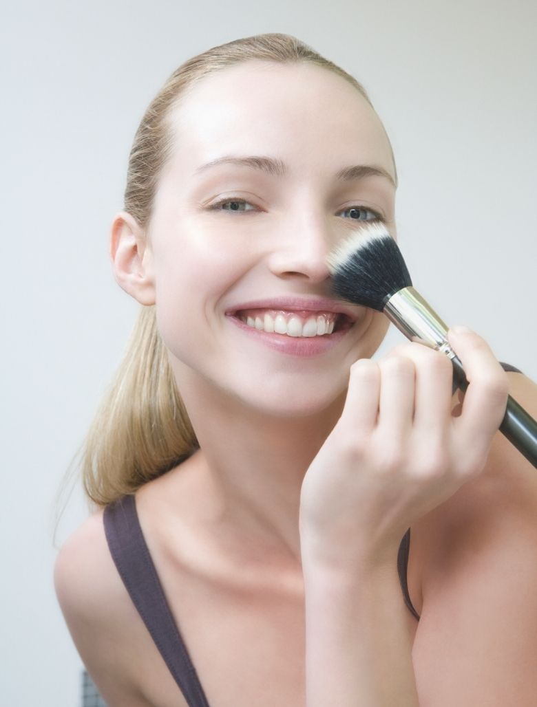 Model holding a make-up brush