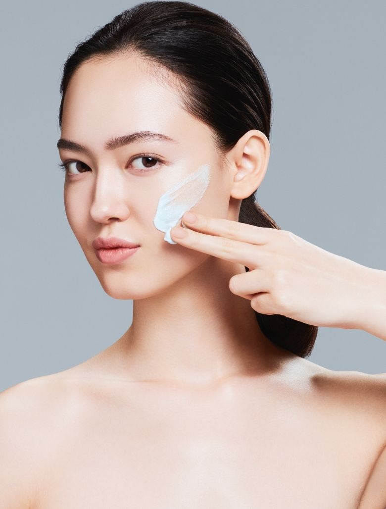 Model applying facial cleanser 