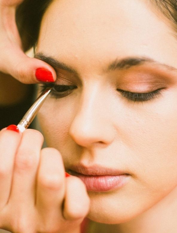 make-up artist applying eyeliner