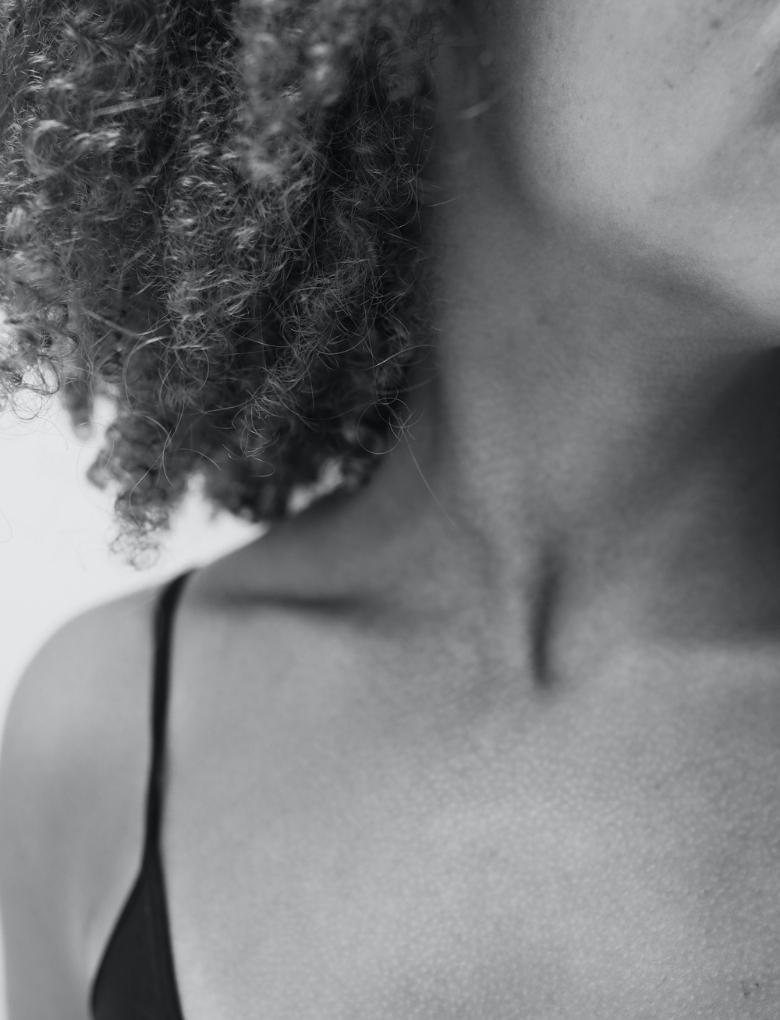 black and white image of neck and décolleté