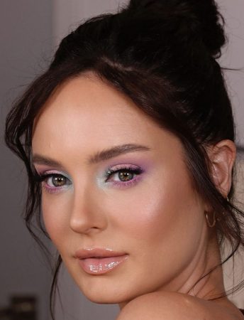 brunette woman with green eyes blue and violet eyeshadows