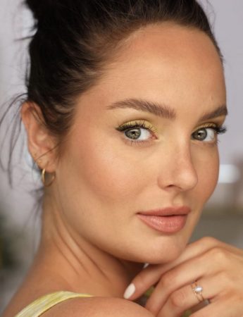 brunette woman with green eyes and yellow eyeshadow
